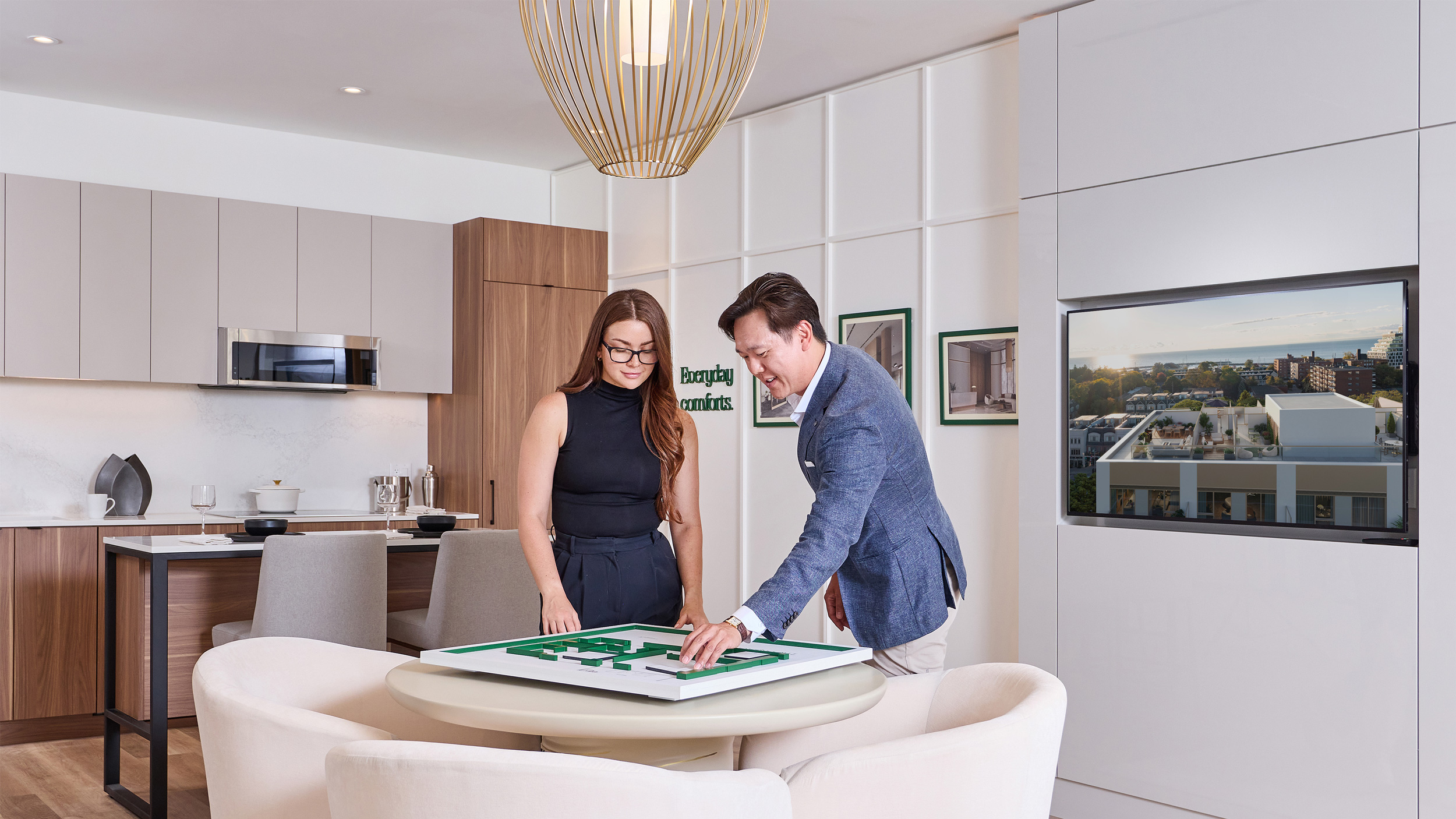 Sales representative showing a purchaser a 3D floor plan inside the Claystone sales office.