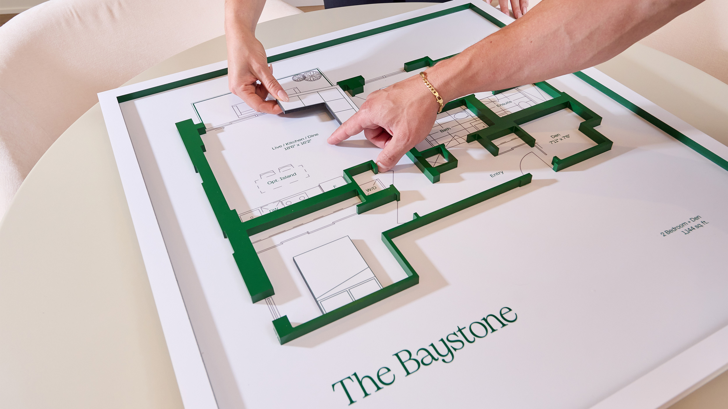 Close-up of 3D floor plan with modular furniture pieces inside the Claystone sales office.
